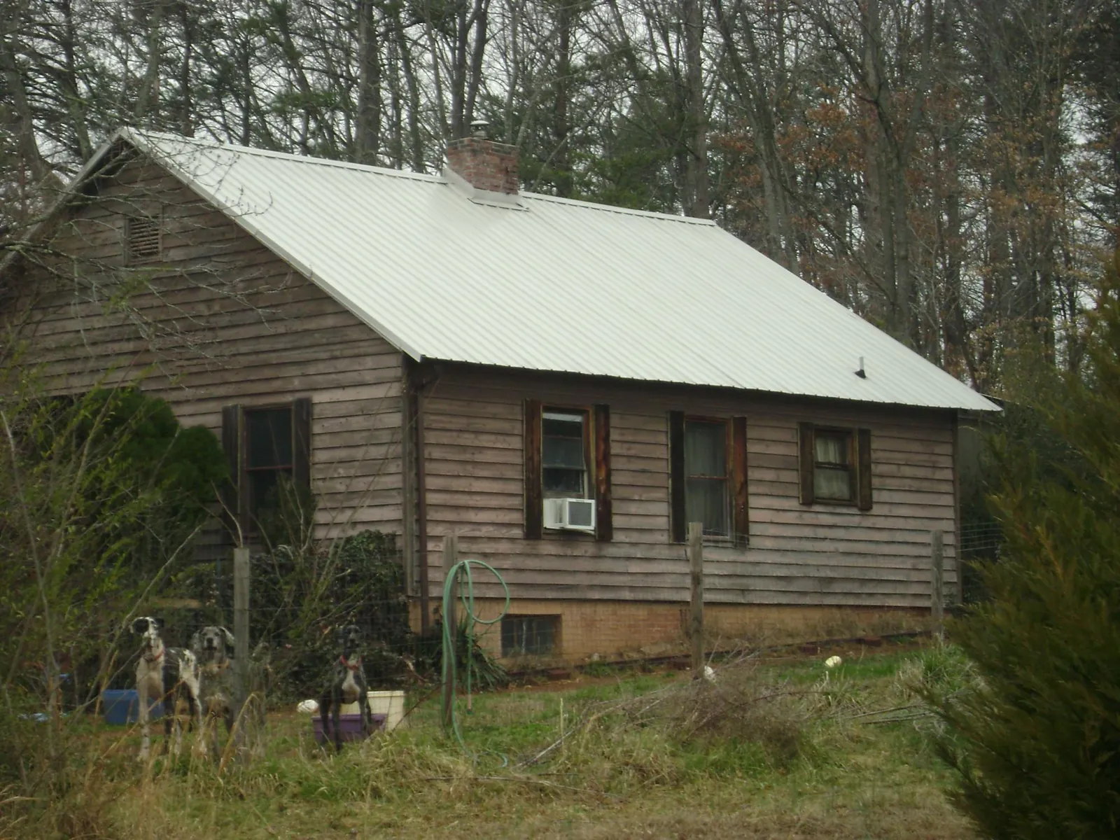 White metal roof on an old wood sided farmhouse, from a Metal Roof Installation job in Piscataway